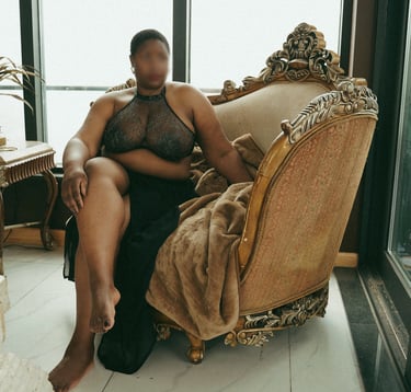 Teal Revel, London Escort, barefoot sitting on a chair