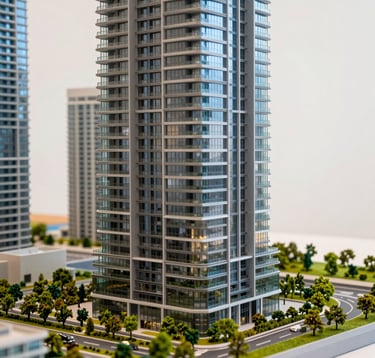 Close-up of a sophisticated architectural scale model of a modern Miami luxury skyscraper, highlighting glass textures and emerald green landscaping, set against a warm white background.