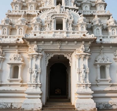A detailed architectural photograph of an ancient South Asian / Indian temple entrance. The Cloud White stone displays intricate carvings, highlighted by the soft morning sun. The composition is clean and professional.
