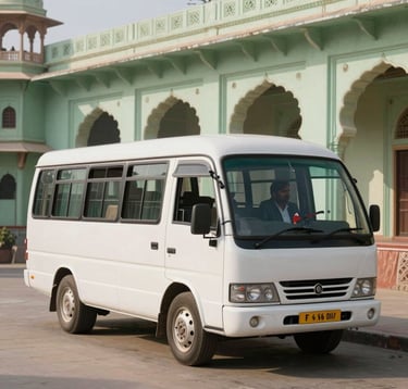 A clean, white luxury travel coach parked in a sunlit plaza in Vrindavan, Rajasthan. A professional driver stands respectfully nearby. The building in the background features traditional arched architecture in pale green stone.