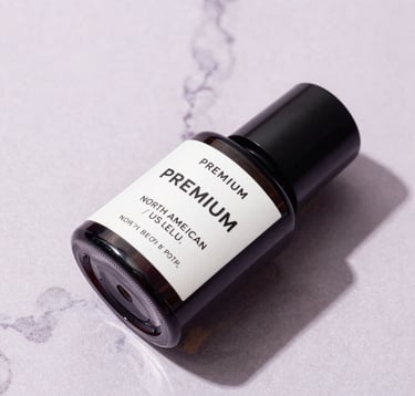 Premium photography of luxury beauty packaging on a soft lavender marble surface. The lighting is bright and clean with soft shadows, reflecting a high-end North American / US lifestyle aesthetic.