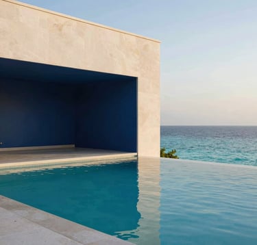 A close-up photograph of a luxury resort infinity pool that merges with a turquoise ocean at dawn. The architecture is modern and minimalist with clean lines. Soft off-white stone and deep navy blue shadows create a peaceful, premium aesthetic. Global / Sophisticated Traveler setting.