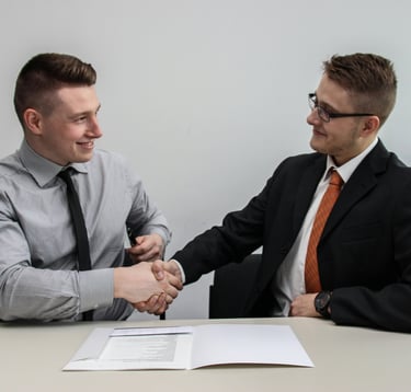 Two men handshaking displaying teamwork.