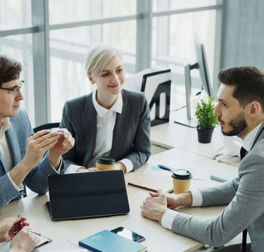 Meeting of four people discussing strategy and results