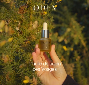 a person holding a bottle of oil and a bottle of oil