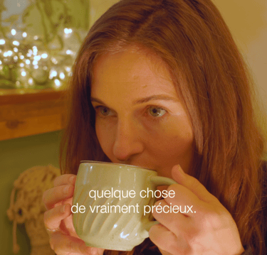 a woman is drinking a cup of tea
