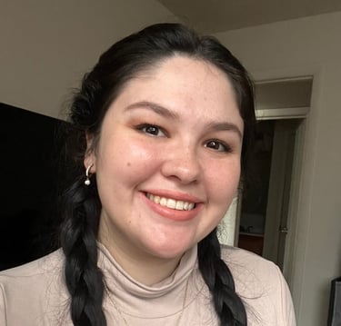 a woman with long hair and a necklace