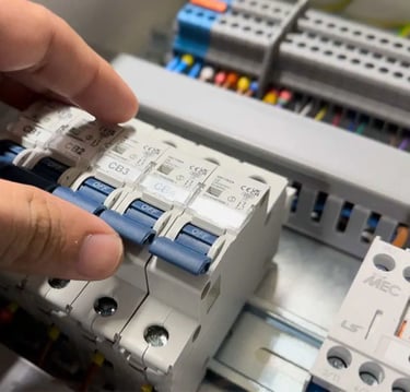 Suasana Electrical Services installing circuit breakers in DB box.