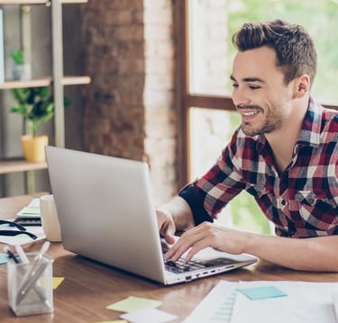 Smiling man in front of computer
