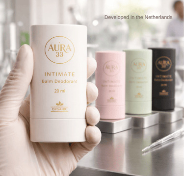 Hand in a glove holding Aura 33 Organic Intimate Balm Deodorant in a laboratory setting.