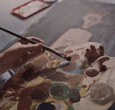 Photo of an artist painting a picture