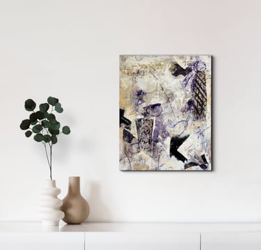 A painting in soft shades of purple and ochre against a warm white wall.