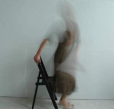 a blurry image of a woman getting up from a chair