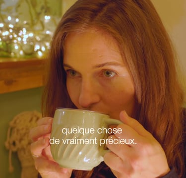 a woman is drinking a cup of tea