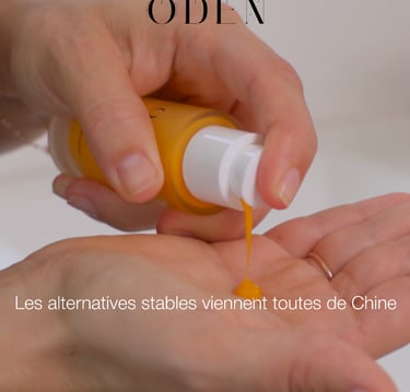 a person holding a bottle of liquid of cosmetic in their hand