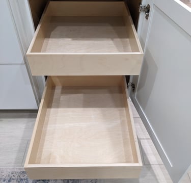 Two custom slide out shelves extended from a white kitchen cabinet.