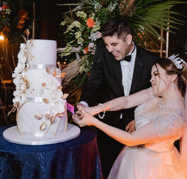 a bride and groom cutting their wedding cake