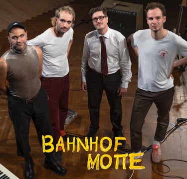 a group of men standing in front of a piano