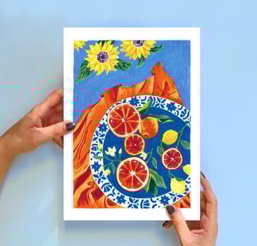 a person holding a painting of a plate with oranges