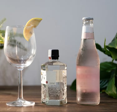 a bottle of gingeze with a glass of gin.Guest Experience Enhancement with Timea Pokol