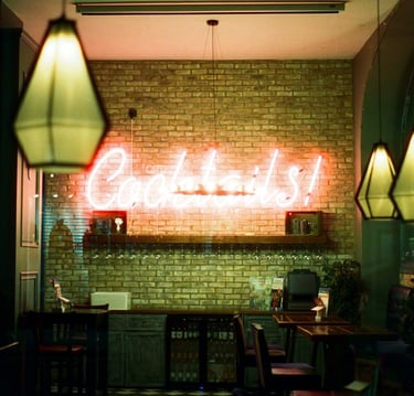 a neon sign that says' Coctails in a bar.Hospitality Startup Guidance with Timea Pokol Consultant