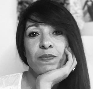 a woman with long hair and a white shirt