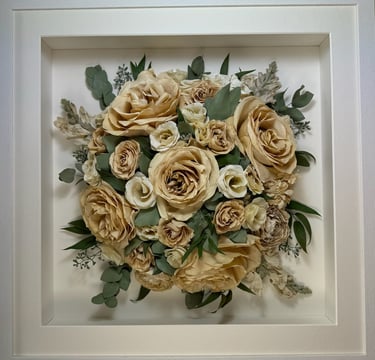 a Birdseye view preserved wedding bouquet in a frame
