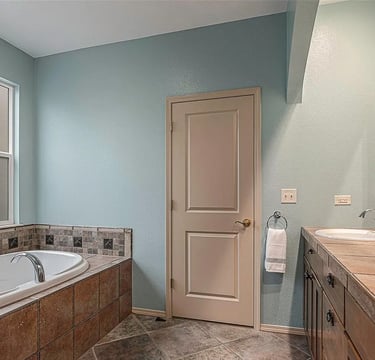 a bathroom with a tub and a large tub