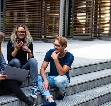 group of young millennials chatting in group on stairs representing gold ira for millennials