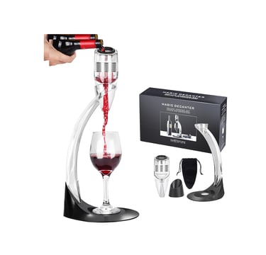 a wine glass being poured with red wine