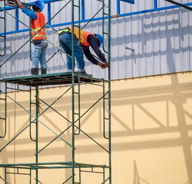 Obreros subidos a un andamio con peligro de caida
