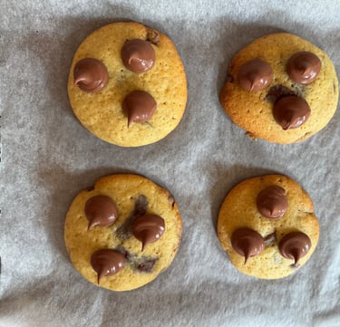 a bunch of chocolate chip cookies on a baking sheet