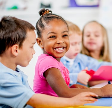 Children smiling and coloring