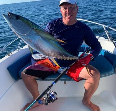 Tourist enjoying a successful catch during a Zanzibar fishing game experience