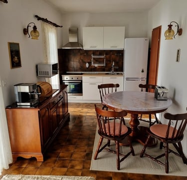The photo shows the apartment's kitchen and dining area from an elevated perspective.