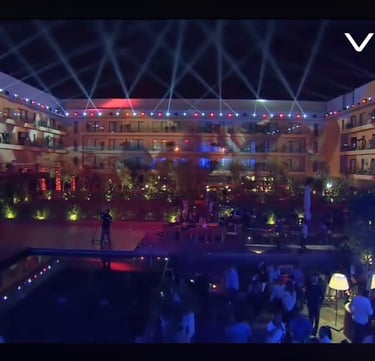 a man standing in front of a pool with a crowd of people