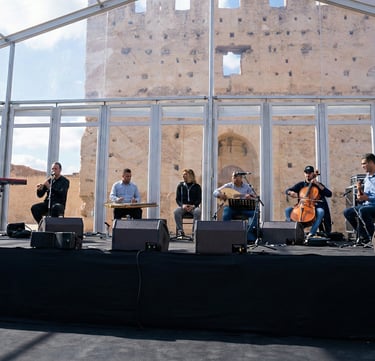a group of people standing on a stage with instruments