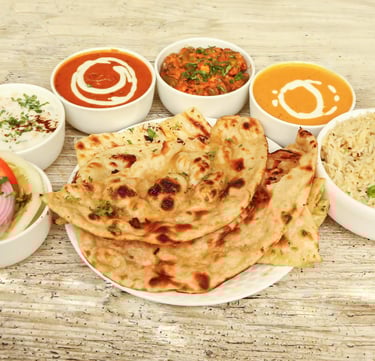 Traditional Indian thali with curry, rice, naan, and flavorful spices