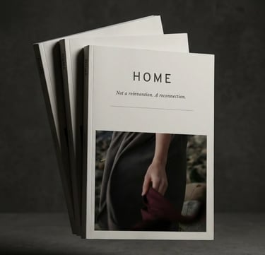 A stack of minimalist HOME lifestyle journals floating against a dark, textured gray background.