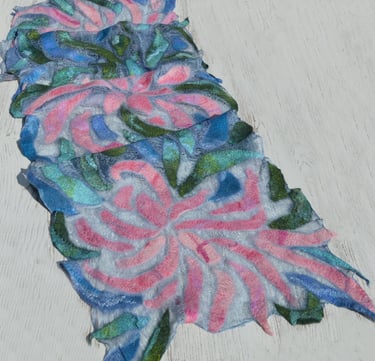 Handmade nuno felted scarf featuring pink and blue floral patterns on a transparant silk 