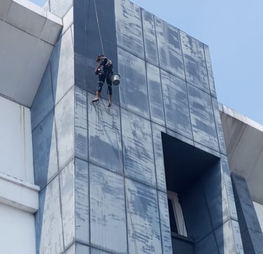 a man on a rope rope with a rope attached to a building