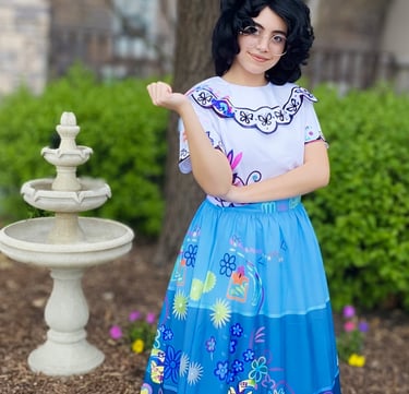 A Columbian inspired character standing by a garden fountain.
