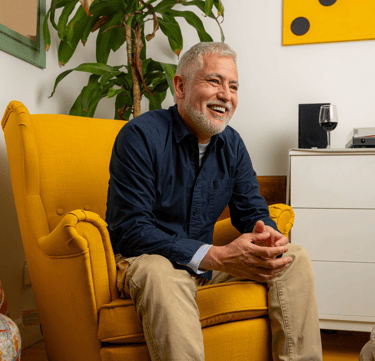 Hispanic man smiling in  chair