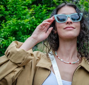 Woman smiling with eco-conscious eyewear outside