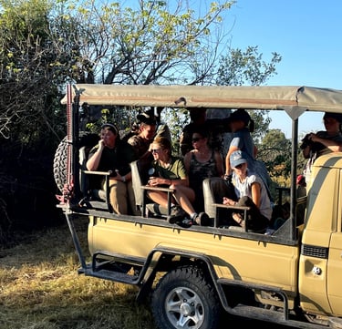 Students on a game viewer admiring wild animals