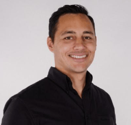 a man in a black shirt smiling