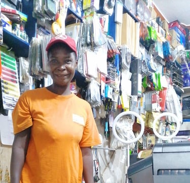 a woman in a orange shirt and a red hat