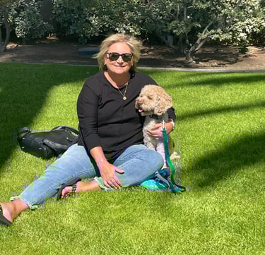 Kelly and Ollie sitting in green grass