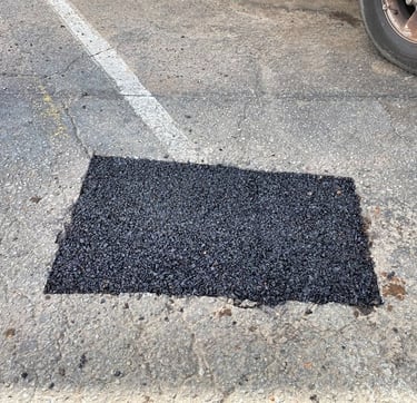 Finished unsealed parking lot pothole repair