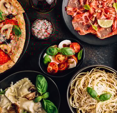 An appetizing spread of classic Italian cuisine, featuring a steaming plate of pasta with rich tomat
